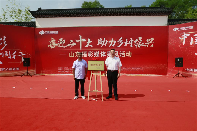 省福彩中心主任王偉與沂源縣徐家莊中心學校校長傅懷佳共同為“福彩希望圖書室”揭牌。 山東省福彩供圖）
