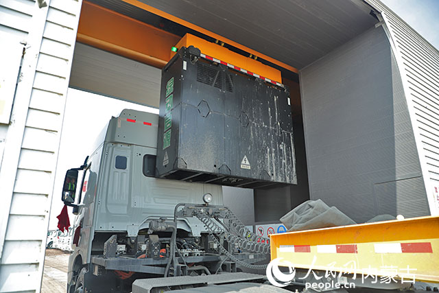 萬(wàn)利新能源數(shù)字陸港里，正在充換電站進(jìn)行換電的重卡。人民網(wǎng)記者 趙夢(mèng)月攝