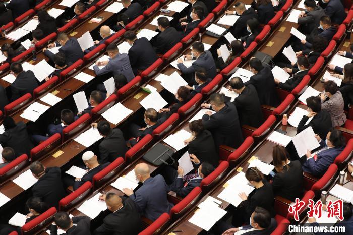 圖為會議現(xiàn)場，參會代表正在聽取政府工作報告?！∑钤鲚?攝