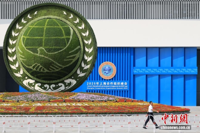 8月31日，天津，一名工作人員從2025年上海合作組織峰會主會場外的景觀花壇旁經(jīng)過。當(dāng)日，2025年上海合作組織峰會在天津舉行。<a target='_blank' href='/'><p  align=