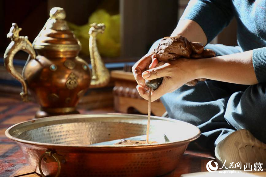 牛角鉆孔，將木泥擠出。人民網(wǎng)記者 次仁羅布攝