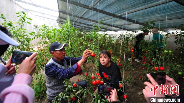 圖為群培(左)為青年職工進(jìn)行技術(shù)指導(dǎo)?！垈?攝