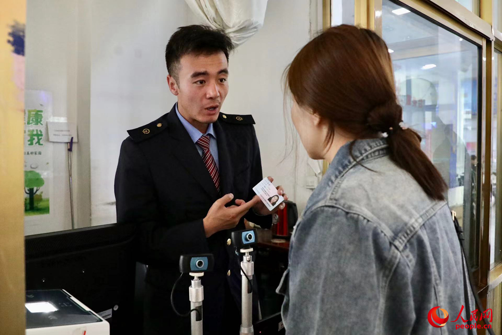 車(chē)站工作人員向旅客解答疑問(wèn)。人民網(wǎng)記者 次仁羅布攝